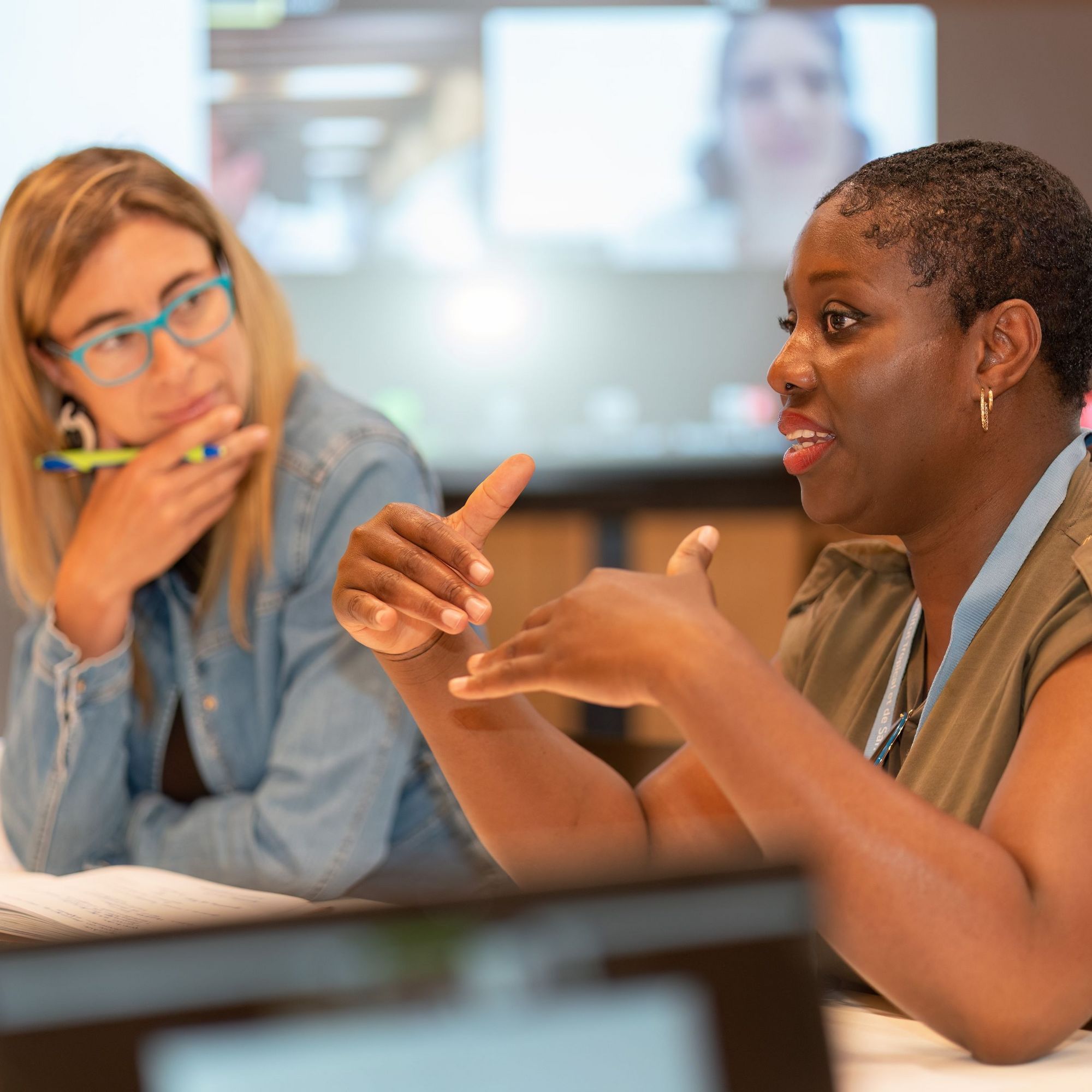 Two students attending a management course lecture at Swiss TPH