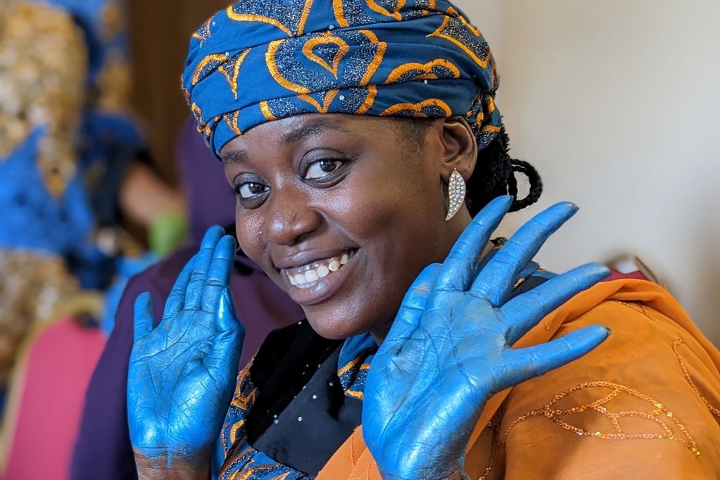 Woman with blue-painted hands