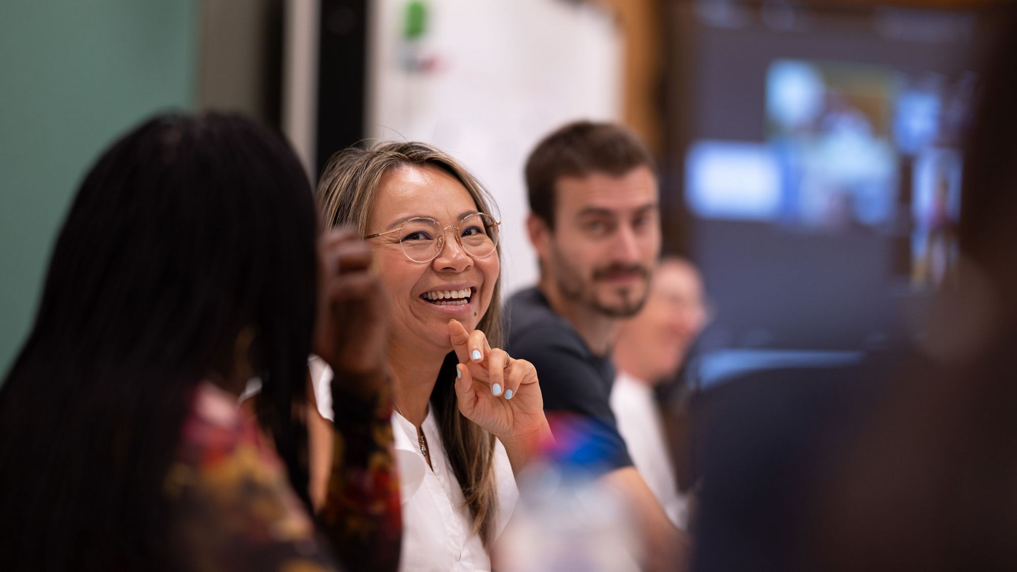 female MBA student smiling in class