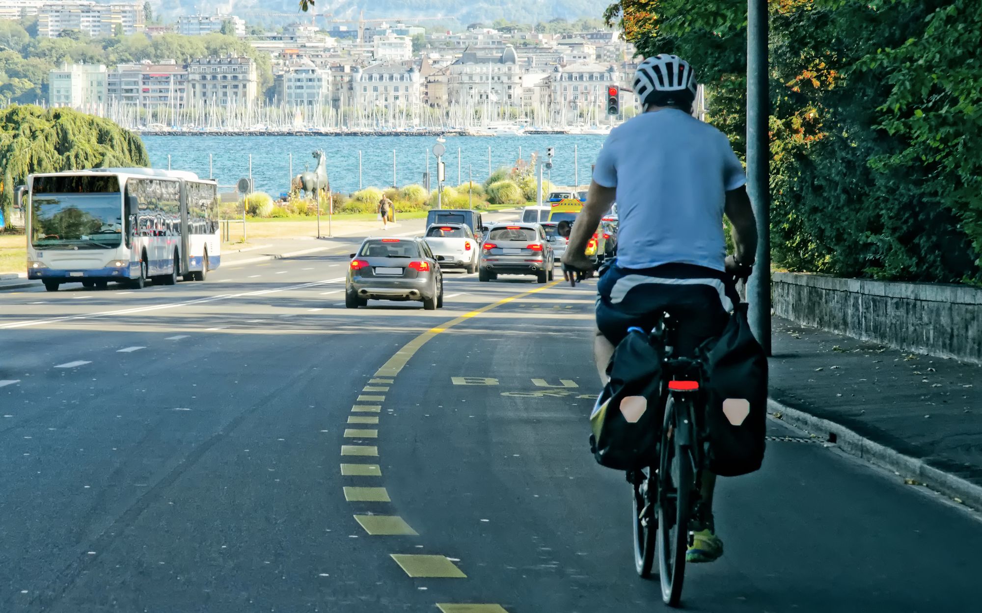 Man on bicycle on road in Geneva Switzerland