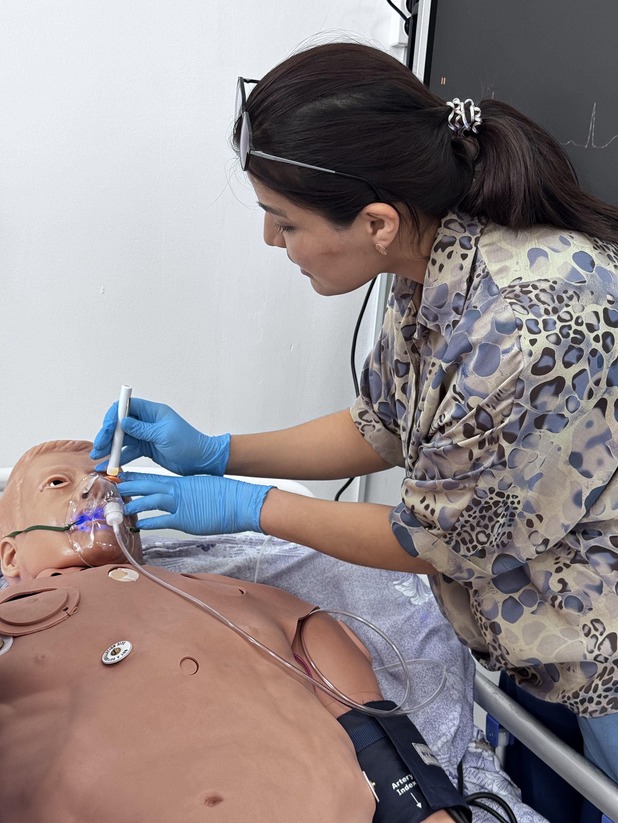 Simulation-based training: a participant conducts a neurological assessment (pupil examination) on a manikin.