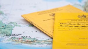 Close Up of Vaccination Certificate and world map.