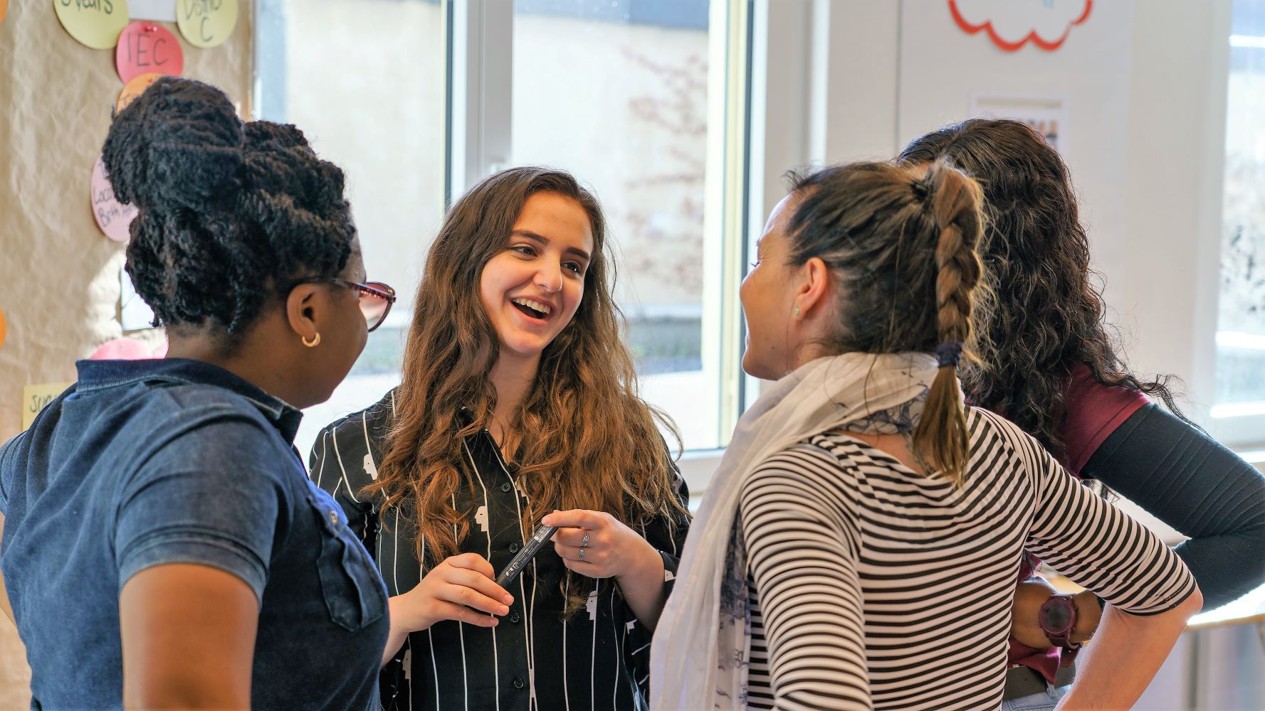 An international group of healthcare and management students engaged in discussion.