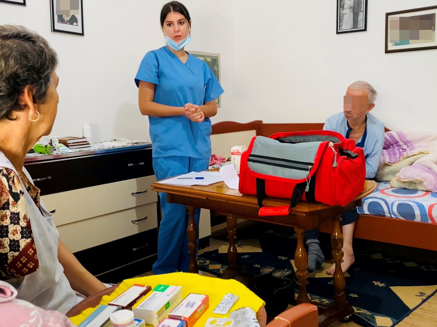 Nurse talking to patient and his wife during a home visit (HAP Albania)