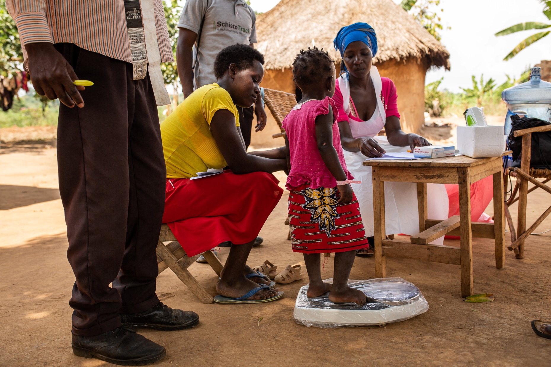 The patient is weighed before the medicine is administered. (Photo credits: Kibuuka Makisa/Candid Local)