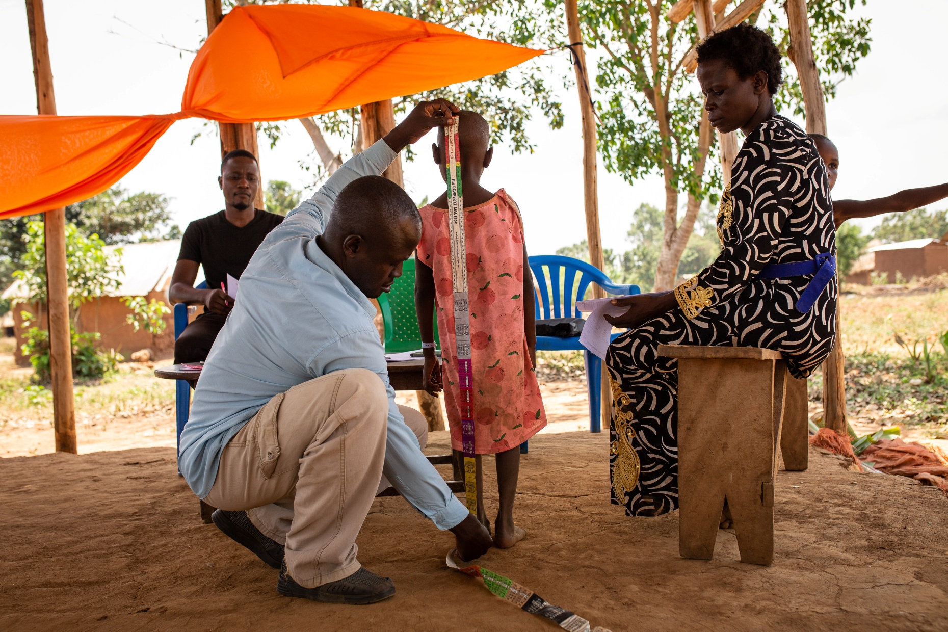 Before administering the medicine, the patient’s height is measured. (Photo credits: Kibuuka Makisa/Candid Local)