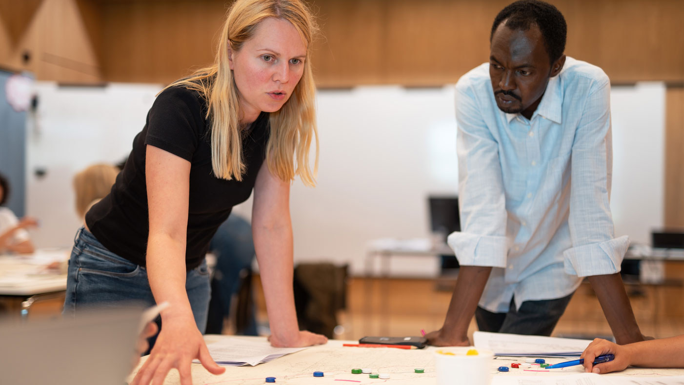 Two students discussing in a CAS Health Research and Interventions lecture